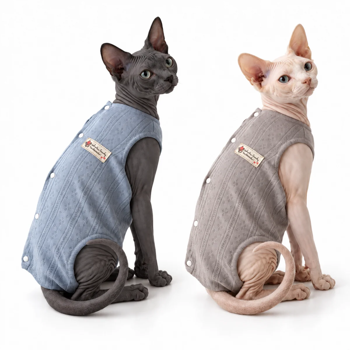 Two cats wearing Sleepy Blue and Oatmeal Cloud lightweight cotton cat pyjama onesies