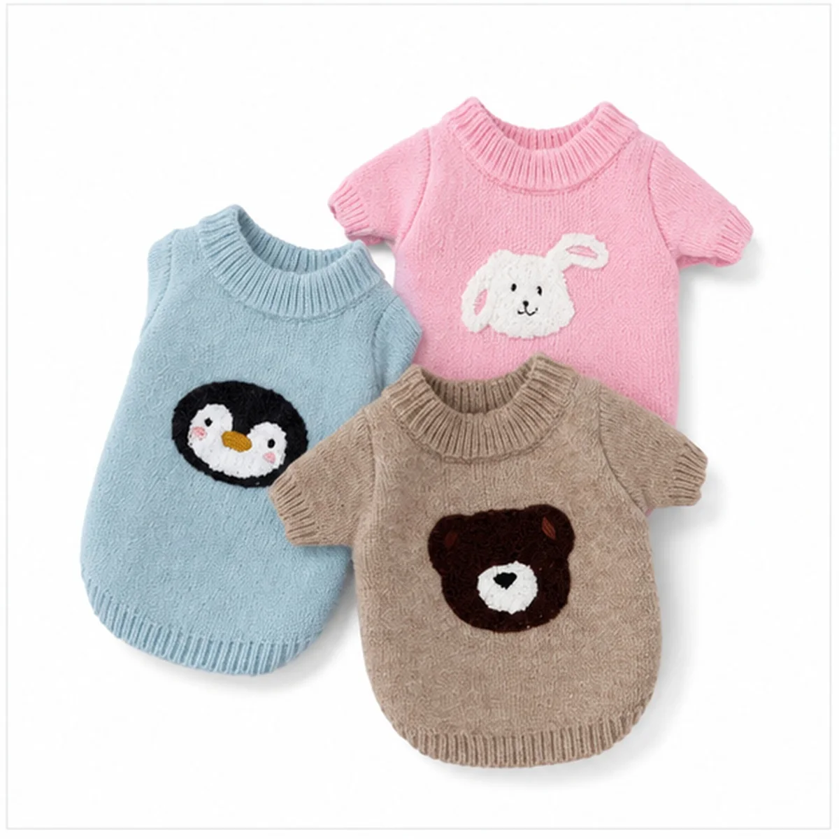Cuddle Crew Cat Sweater three-piece studio assortment: blue penguin, pink bunny and beige teddy designs on white background