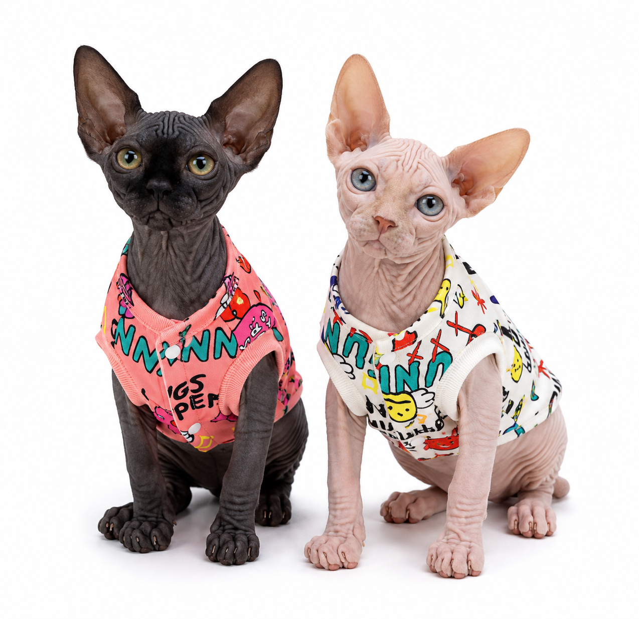 Two hairless cats sitting side-by-side wearing pink and white Fries Before Guys Jackets, front lifestyle view.